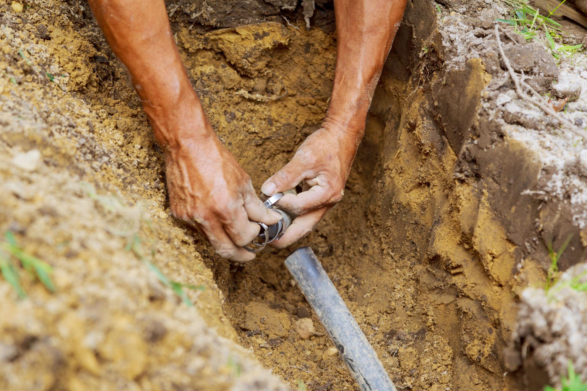 Irrigation line repair in a landscaped yard
